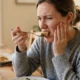 Person experiencing tooth hurts when biting down discomfort while eating